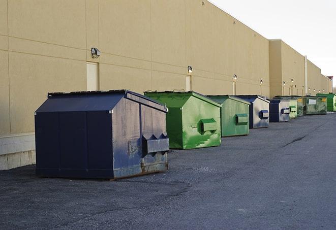 a row of blue construction dumpsters on a job site in Buffalo